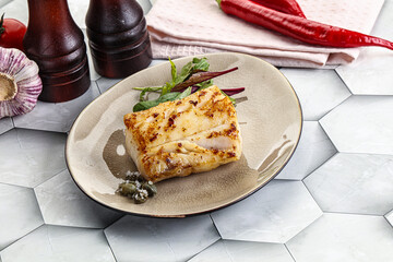 Roasted cod fish steak with salad