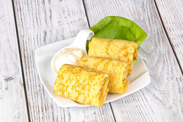 Stuffed pancakes with cream sauce