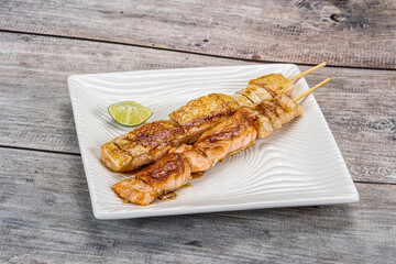 Grilled salmon skewer with sauce