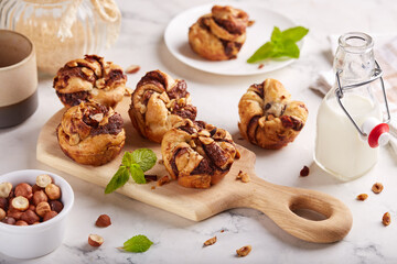 Puff pastry muffins with chocolate and hazelnuts. Delicious homemade rolled up buns. 