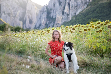woman in red dress with white dog in nature