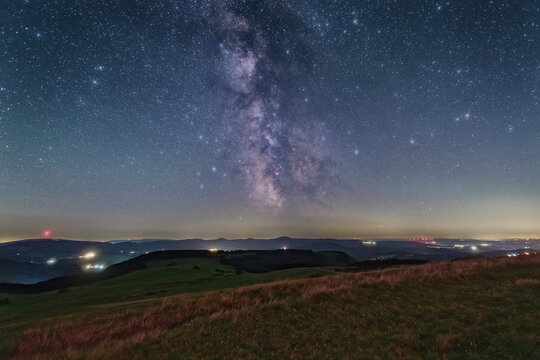 The Milky Way over the summit of the mountain Wasserkuppe in the Rhoen in Germany.