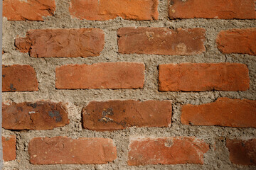 brick wall of red color. brick wall with lots of cement.