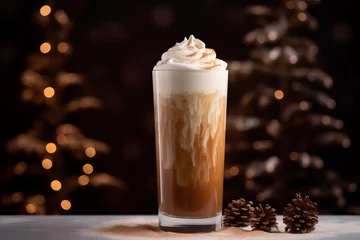 Fototapeten a tall glass with warm coffee drink with cinnamon, whipped milk foam or cream and caramel on a kitchen table and christmas ornaments, lights and decoration. © Romana