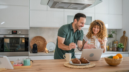 happy couple man and woman husband and wife morning routine use laptop