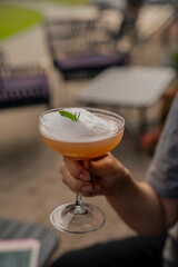 Breezy white foam cocktail with peppermint at cocktail bar