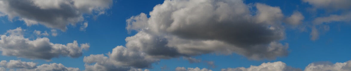 white and gray clouds in the blue sky, layered rain clouds, stratocumulus, cumulonimbus,...