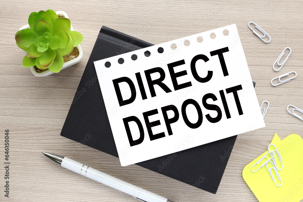 Poster direct deposit text on page on black notebook on table