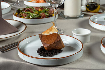 Chocolate for dessert - healthy organic dessert pie cheesecake. Designer dessert in the shape of a cube and with cream.