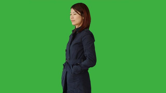 Lifestyle Portrait of Chinese Female Person against Green Background