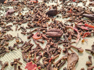 Variety of spices on bay leaf, ingredients for garam masala with Indian Chef statue, indian spice mix