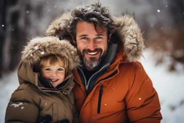 Obraz premium Father lifting little son up while having fun together outdoor on frosty day