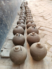 Fototapeta na wymiar Coin box called Gullak drying in sunlight, Indian village life, clay business