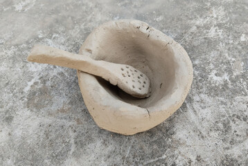 Handmade clay toys for kids to play. Indian small toy kitchen vessels made of soil on the floor. ...