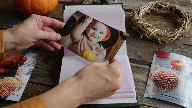 Photo printing, Halloween memories concept. Female hands hold Halloween printed photo.