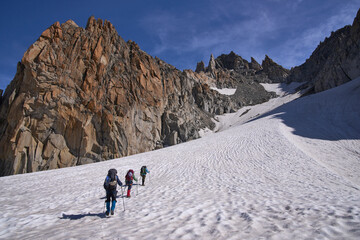 A group of climbers ascending to the pass Col Superieur du Tour, French Alps. Glacier Haute Route Chamonix - Zermatt. Alpinism and active tourism.