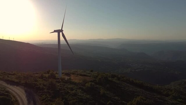 eolic generators spining with the wind  at sunset in the Ribeira Sacra, Galicia Spain