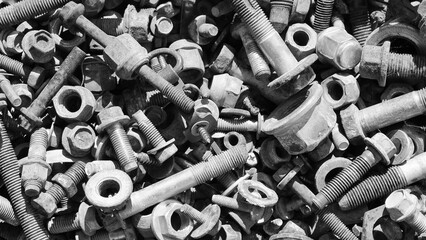 gray background, photo shows old rusty bolts, nuts and screws