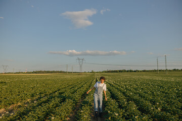 Professional woman agronomist on potato field background. Agriculture concept