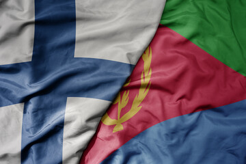 big waving national colorful flag of finland and national flag of eritrea .