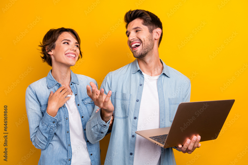 Poster photo of two people coworkers browsing netbook searching eshop sales discussing isolated bright colo