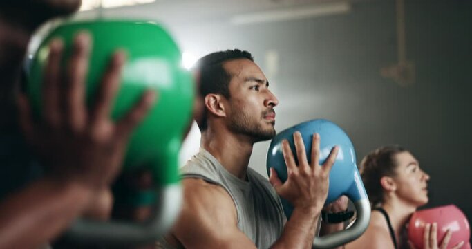 Gym, group fitness and kettlebell squat exercise for power, sports challenge and muscle. Serious asian man, bodybuilder and heavy weights for training in health club, workout class and strong friends