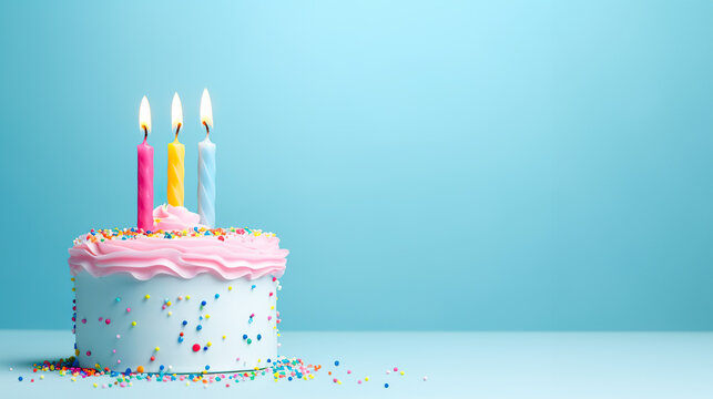 Birthday cake with 3 candles on pastel blue background with copy space	