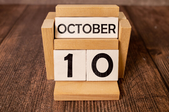October 10, Cover design with number cube on a white background and granite table.