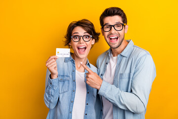 Photo of excited shocked bankers advertising recommend special offer banl card demonstrate isolated...