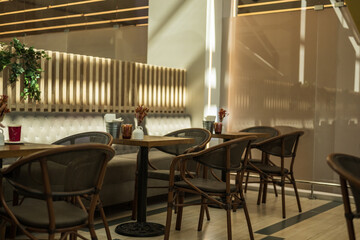 Interior of a modern cafe with wooden tables and chairs
