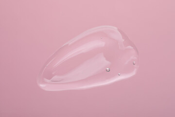 Sample of cleansing gel on pink background, top view. Cosmetic product