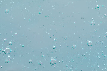 Transparent cleansing gel on dusty light blue background, top view. Cosmetic product