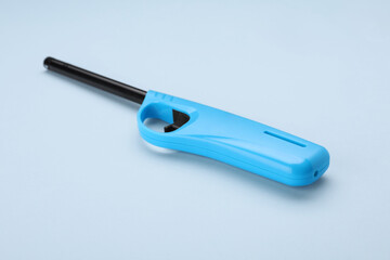 One gas lighter on light blue background