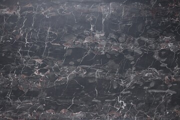 Dark grey marble surface as background, closeup