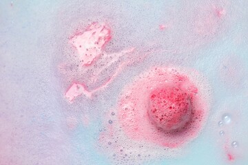 Beautiful pink bath bomb dissolving in water