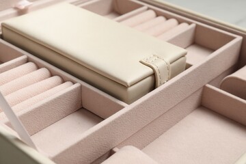 Empty beige jewelry box on table, closeup
