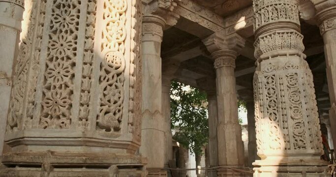 Columns of beautiful Ranakpur Jain temple or Chaturmukha Dharana Vihara. Marble ancient medieval carved sculpture carvings of sacred religious place of jainism worship. Ranakpur, Rajasthan. India