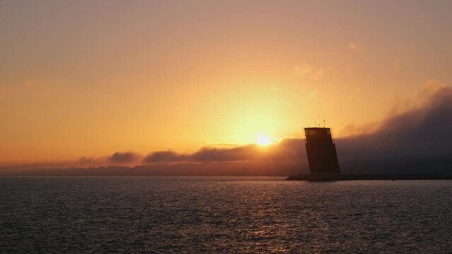 Torre VTS de Lisboa, VTS Vessel Traffic Systemtower, Centre for Coordination and Control of Maritime Traffic and Safety of Lisbon on bank of Tagus river, Portugal on sunset