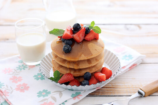 Stacked Pancakes with Strawberry, Blueberry, and Maple Syrup
