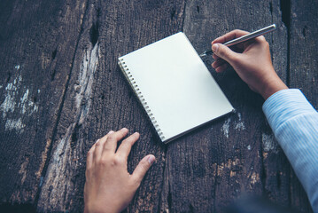 Businesswoman hands note document. Hands writing on empty notebook. Woman planning working on eco sustainable outdoors. Female hand holding pencil write on blank sketchbook. Mock-up Concept
