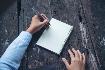 Businesswoman hands note document. Hands writing on empty notebook. Woman planning working on eco...