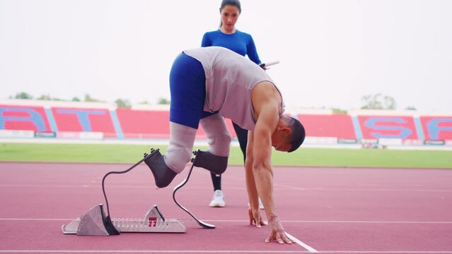 Asian athlete with prosthetic blades and trainer workout in stadium. 