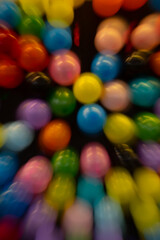Fototapeta na wymiar vertical abstract motion blur background of colored balloons at fair special movement effect created by long time exposure shutter speed and in camera movement fun celebratory party birthday backdrop 