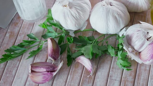 Parsley and garlic on wooden table. Preparing food concept.