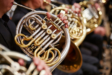 Close up of person hands playing horn	