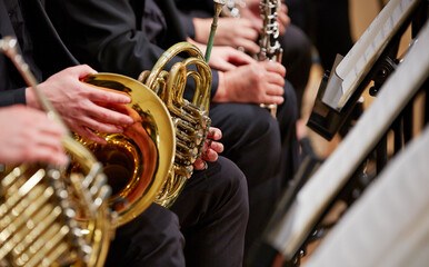 Close up of person hands playing horn	