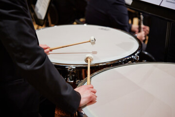 Close up of male hands playing drums at concert