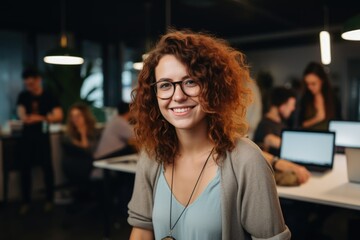 Smiling portrait of a happy young caucasian woman working for a modern startup company in a business office