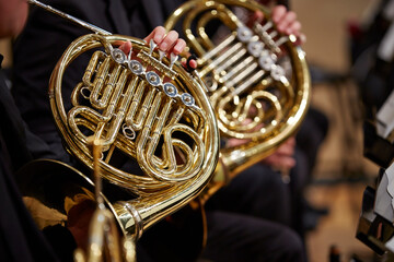 Fototapeta premium Close up of performer's hands playing horn