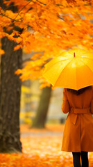 A woman in a raincoat, holding an umbrella, standing amidst fall colors.